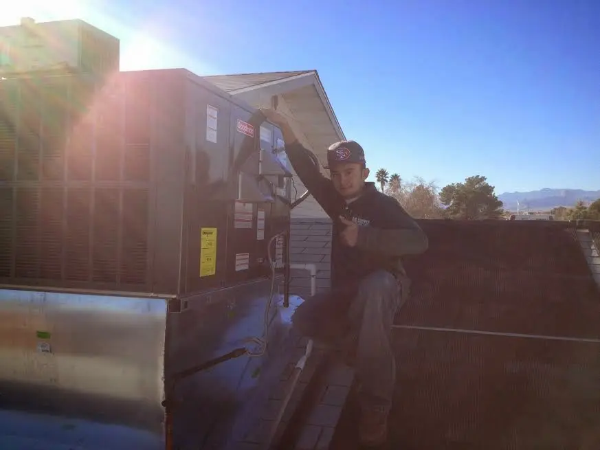 HVAC technician performing HVAC Inspection on a rooftop unit in Marysville